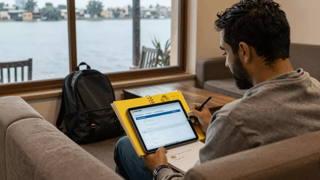 Sri Lankan student planning IELTS study with laptop and notes