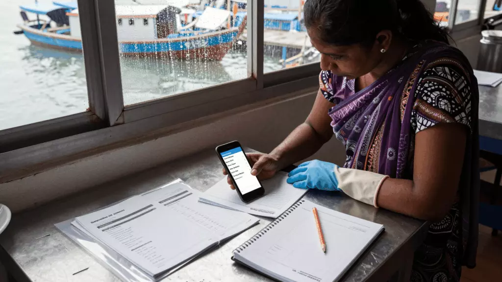 a Bangladeshi woman in her late 20s working through চেক করুন