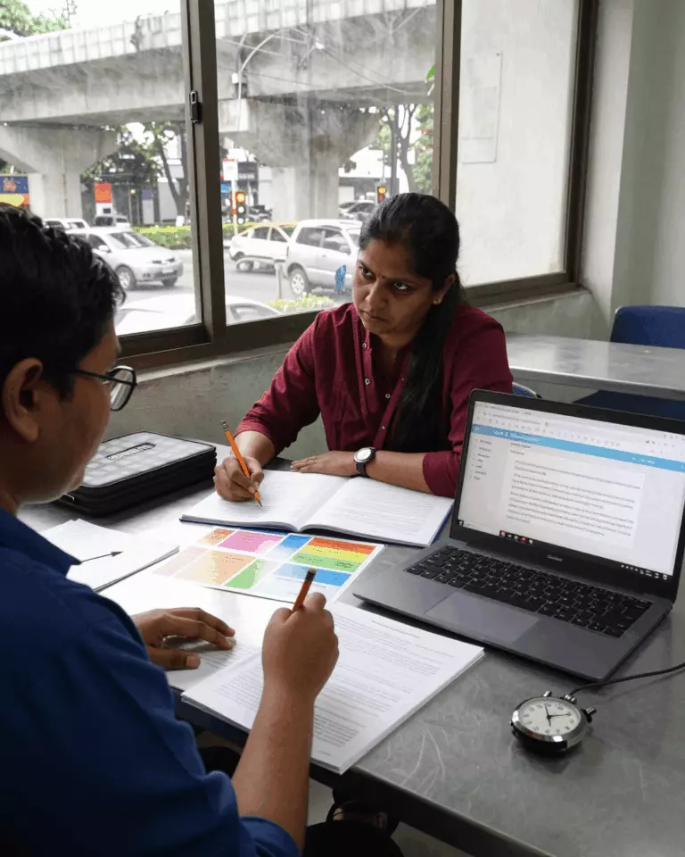 a Bangladeshi woman in her late 20s preparing online for আইইএলটিএস রাইটিং টাস্ক 2 কোর্স গাইড: প্রবন্ধ, ধারণা, কাঠামো এবং ব্যান্ড স্কোর