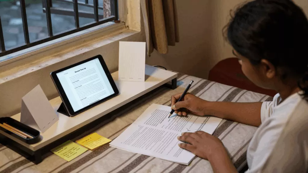 a Bangladeshi woman in her late 20s working through >রিভাইস