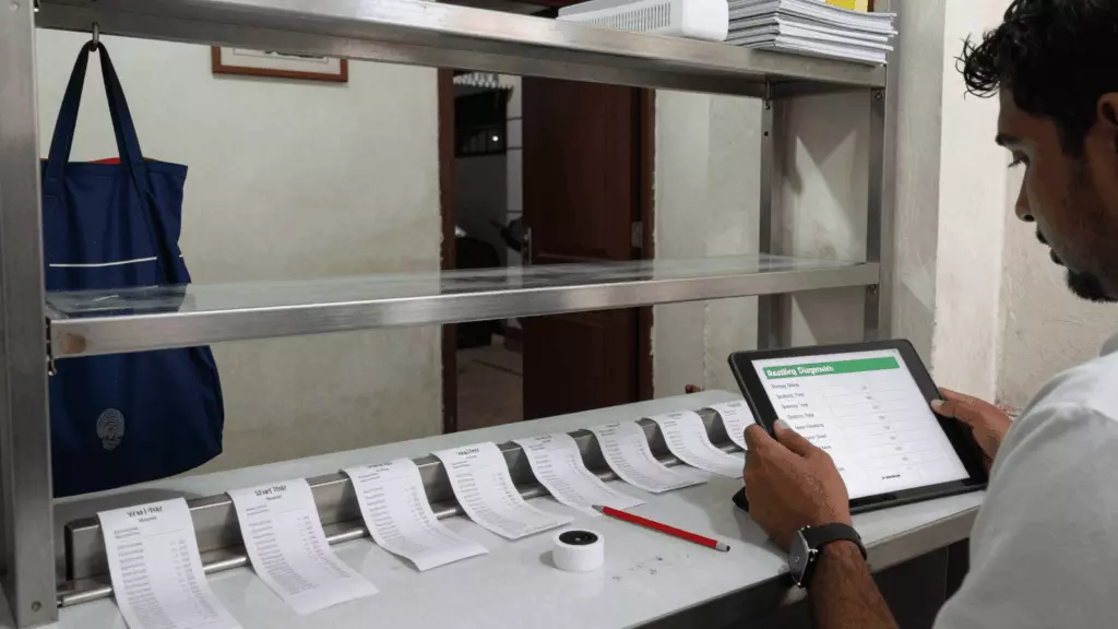 a Bangladeshi woman in her late 20s reviewing an IELTS online course workflow
