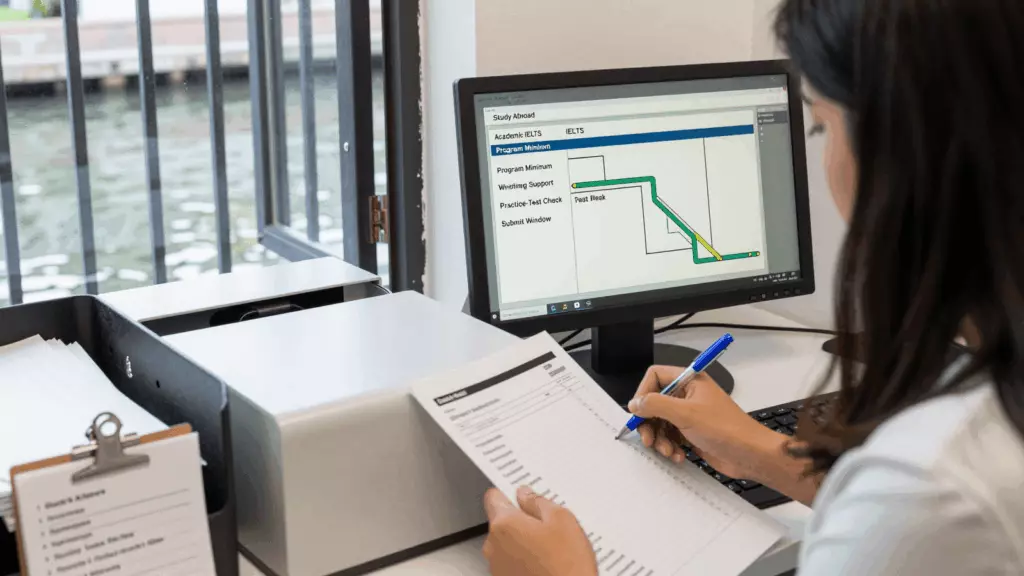 a Latina woman in her late 20s reviewing an IELTS online course workflow