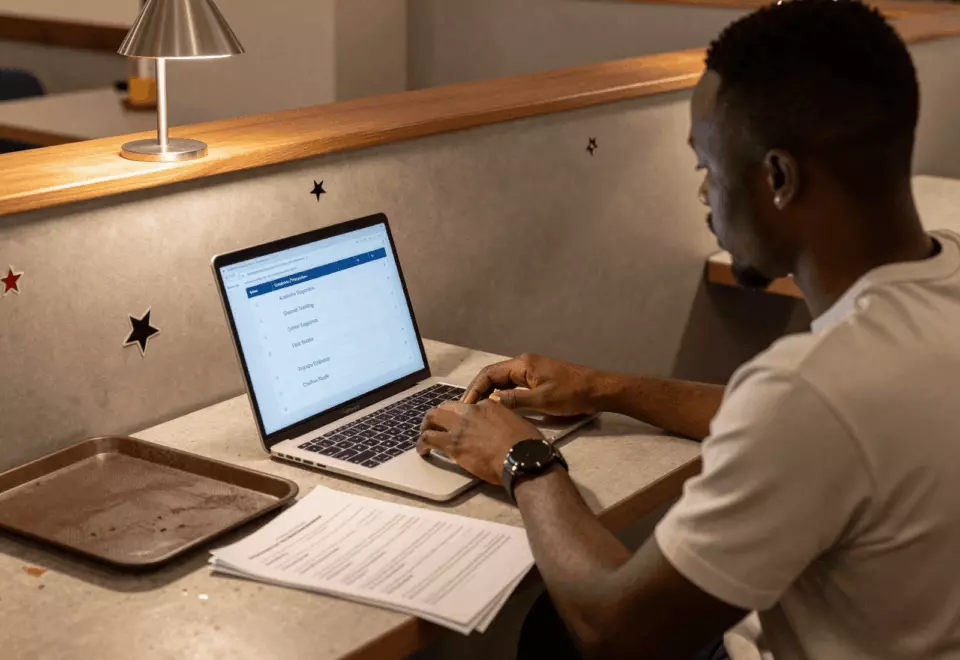 a Francophone African man in his late 20s choosing the next IELTS prep step online