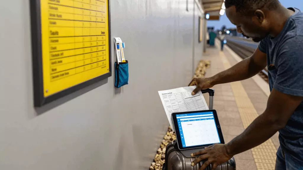 a Francophone African man in his late 20s reviewing an IELTS online course workflow