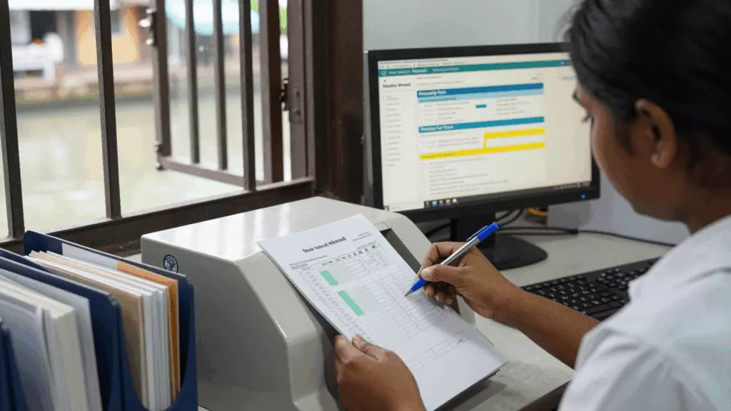 a Sri Lankan woman in her late 20s reviewing an IELTS online course workflow