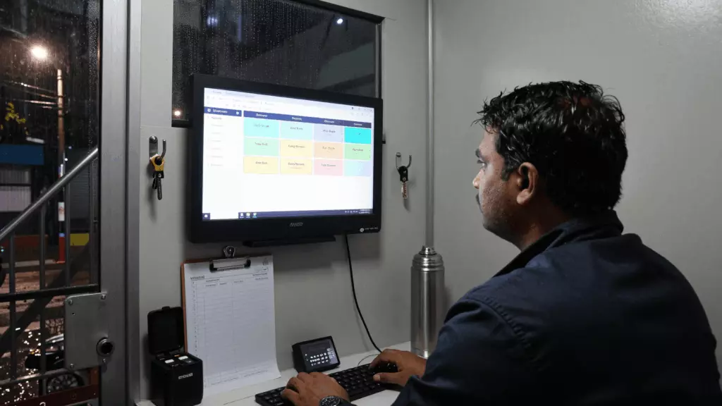 a Tamil woman in her late 20s reviewing an IELTS online course workflow