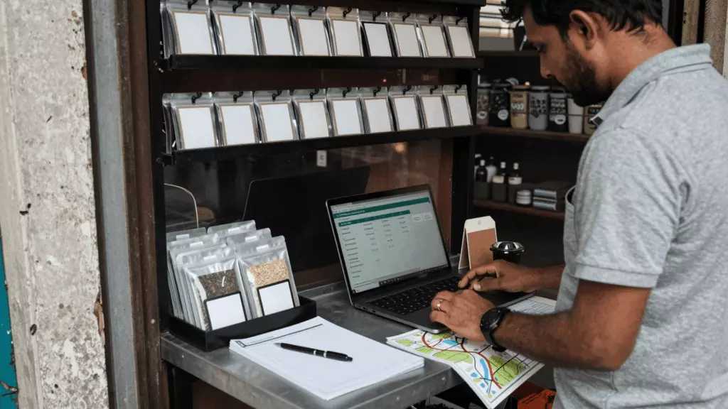 a Tamil woman in her late 20s reviewing an IELTS online course workflow