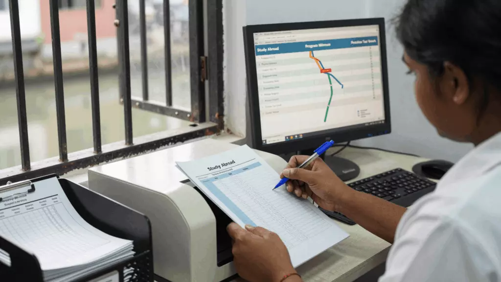 a Tamil woman in her late 20s reviewing an IELTS online course workflow
