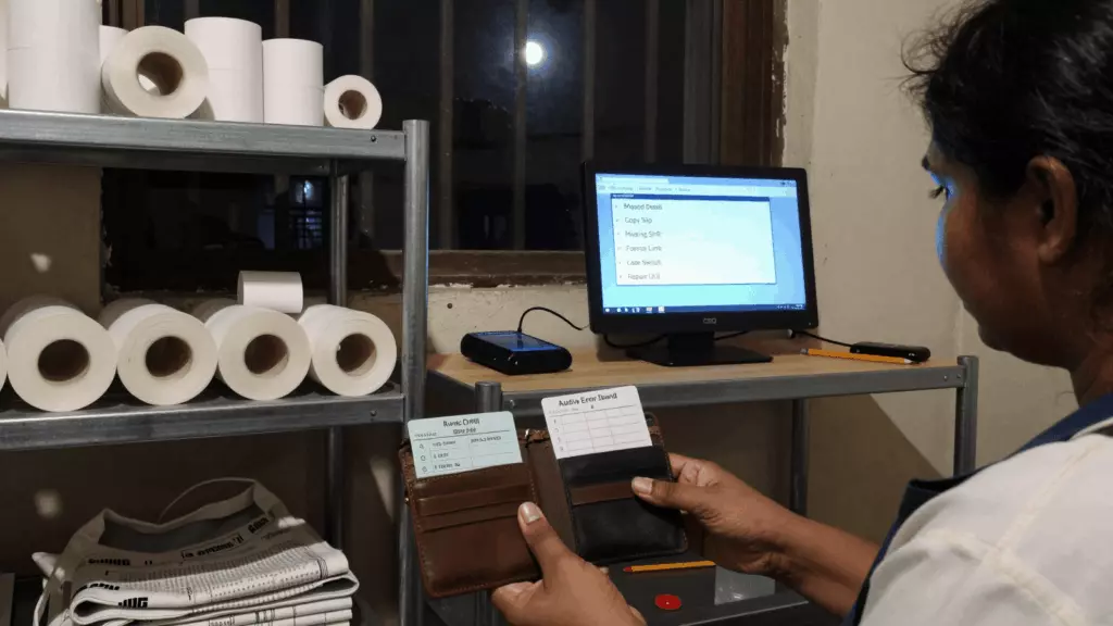 a Tamil woman in her late 20s reviewing an IELTS online course workflow