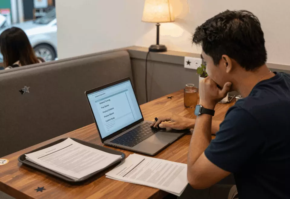 a Thai woman in her late 20s choosing the next IELTS prep step online