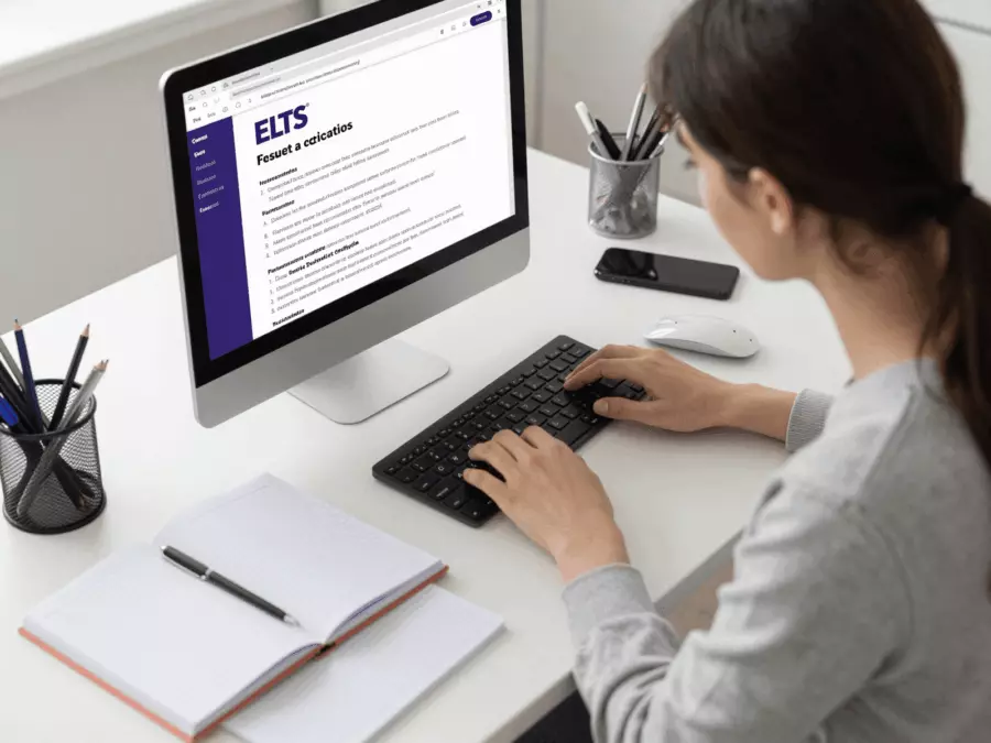 IELTS learner reviewing a writing draft and feedback notes